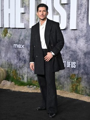 Danny Ramirez poses in a black AMIRI double-breasted suit at The Last of Us premiere in Los Angeles.