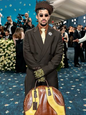 Close-up of Bad Bunny's accessories, including embellished gloves and Prada bag